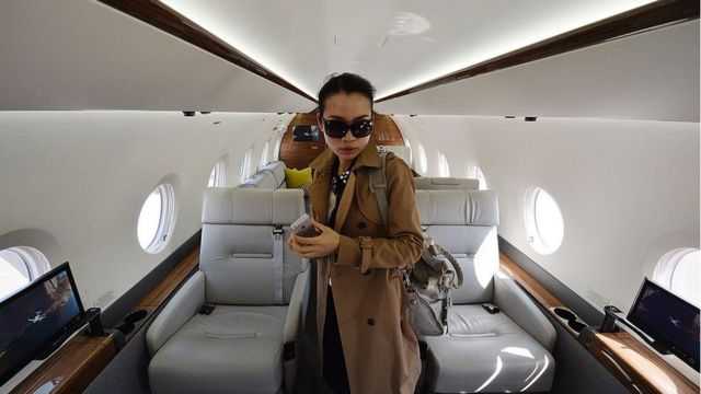 A Chinese woman on a luxury jet